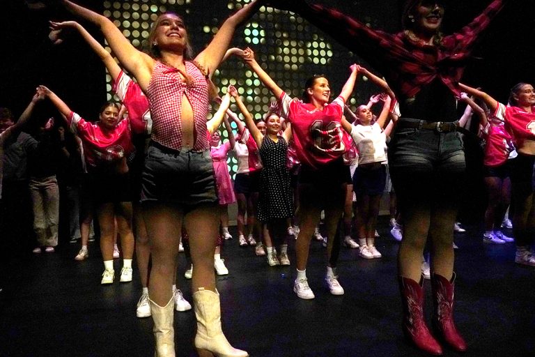 student dancing on a stage final finale